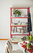 DIY kitchen shelves made from metal rails and wallpapered chipboard shelves