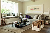 Animal-skin pouffes, grey sofa, modern coffee table and window seat with scatter cushions