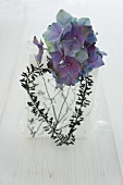 A gift decorated with a hydrangea and a heart