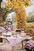 Romantically set table in autumnal garden