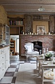 Side tables in rustic living room with simple fireplace in brick surround