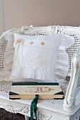 Cushion with white lace cover on antique cane chair