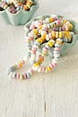 Colourful candy necklaces in china bowls