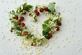 Heart-shaped wreath of wild strawberries and elderflowers