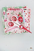 Scissors on folded fabric with vintage patterns
