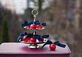 Red apples and dark blue ribbons on silver cake stand