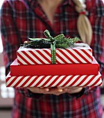 Woman holding stack of Christmas presents