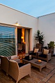 Twilight atmosphere on Mediterranean terrace with wicker furniture