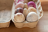 Easter eggs dyed using natural dyes in egg box