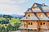 Three-storey log cabin in idyllic mountain landscape