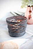Hand-made tealight holder made from glass and dark grey yarn cover