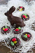 Chocolate Easter bunny amongst shredded paper and sugar nests