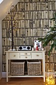 Cream-painted console table against photo mural with bookcase motif