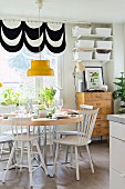 Colourful accessories in Scandinavian-style dining room