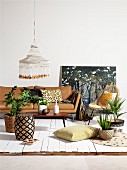 Patterned wicker stool, coffee table, pale brown sofa and house plants
