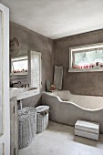 Masonry bathtub in grey limewashed bathroom