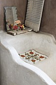 Masonry bathtub with vintage decorations