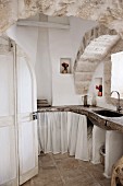 Masonry kitchen counter below arched ceiling