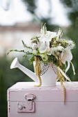 Green and white bouquet with white orchids in watering can