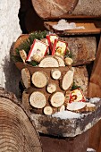 Plant pot full of presents decorated for winter with slices of branches