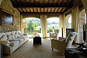 Stone wall and panoramic window in Mediterranean living room