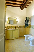 Yellow tiles and wooden ceiling in classic bathroom