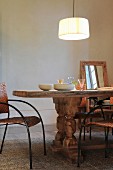 Pendant lamp above rustic wooden table with chunky turned legs