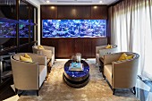 Four armchairs and large aquarium in classic lounge