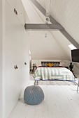 Tall fitted wardrobes in white attic bedroom