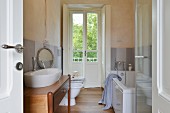 White bathroom suite and oak floor in renovated country house