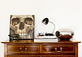 Picture of skull on top of antique chest of drawers