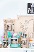 Glass jars covered in vintage-style printed paper holding kitchen utensils