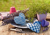Hand-made, heart-shaped lavender sachets on table outdoors