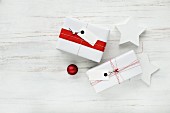 Gifts wrapped in red and white with tags and two stars