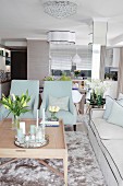 Two pale blue armchairs in elegant interior in pale shades of grey