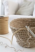 Hand-crocheted basket and crochet hook