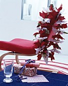 Poinsettia garland on cantilever chair and wrapped gifts