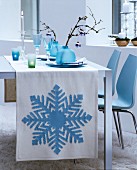 White runner with ice-blue appliqué snowflake motif