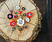 Hand-made buttons for traditional clothing on tree stump