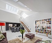 Gallery and skylights in open-plan interior of modern lift apartment with white walls