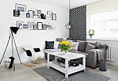 Wooden table, grey couch and framed messages in corner of black and white living room