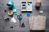 Sewing utensils and accessories on grey table
