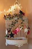 Original, festive arrangement of birdcage and decorations