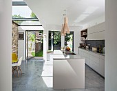 Free-standing counter and glass ceiling in open-plan kitchen