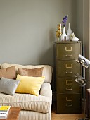 Comfortable sofa, retro filing cabinet and chrome standard lamp