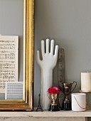 Gilt frame, vintage silver trophy, hand ornament and miniature Eiffel tower on marble mantelpiece