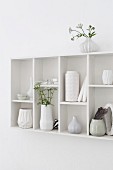 Collection of vases in white-painted, wall-mounted, retro display case