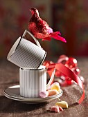 Cups and red bird ornaments decorated with ribbon