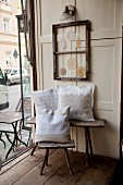 Rustic wooden furniture and lace cushions in vintage-style coffee house