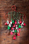 Advent calendar hand-made from numbered bags hung from red coathanger